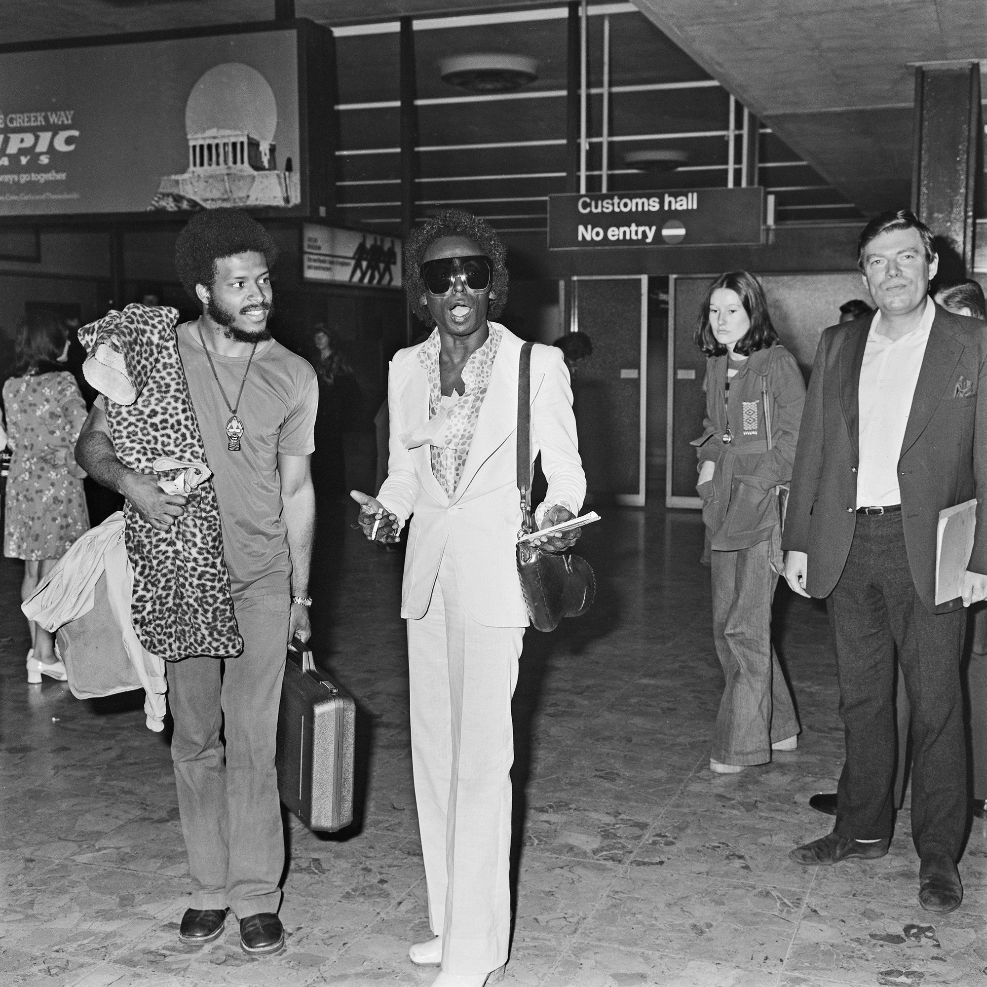 James Mtume (left) and Miles Davis at Heathrow Airport, London, July 1973. Photo by R. Brigden via Express/Hulton Archive/Getty Images.